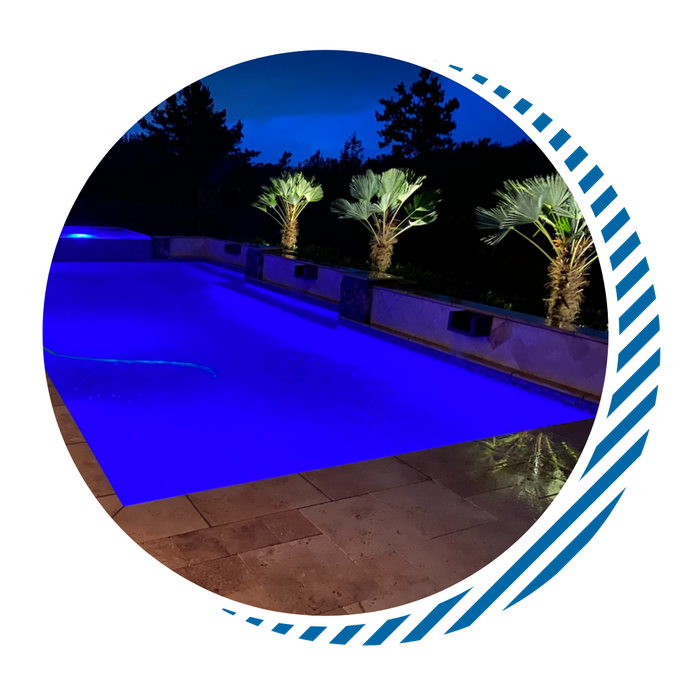 custom pool lit up at night