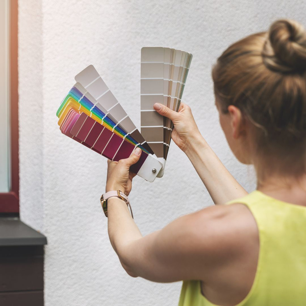woman deciding on paint color for house