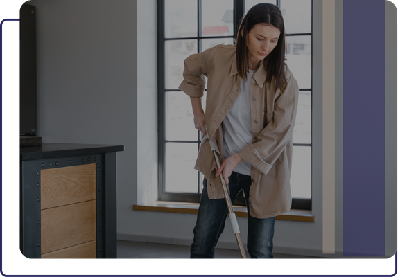 Woman mopping the coated floors of her shop