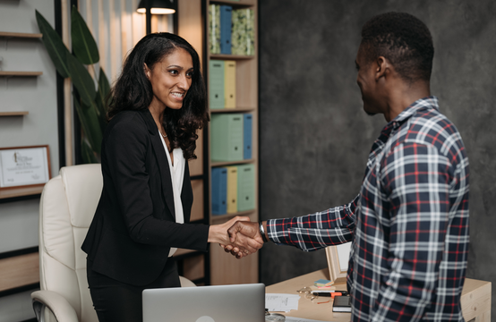 A contractor shaking hands with a customer