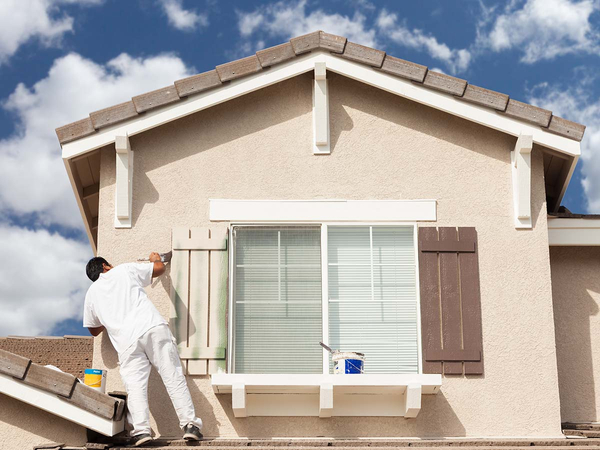 Professional painter painting the exterior of a house