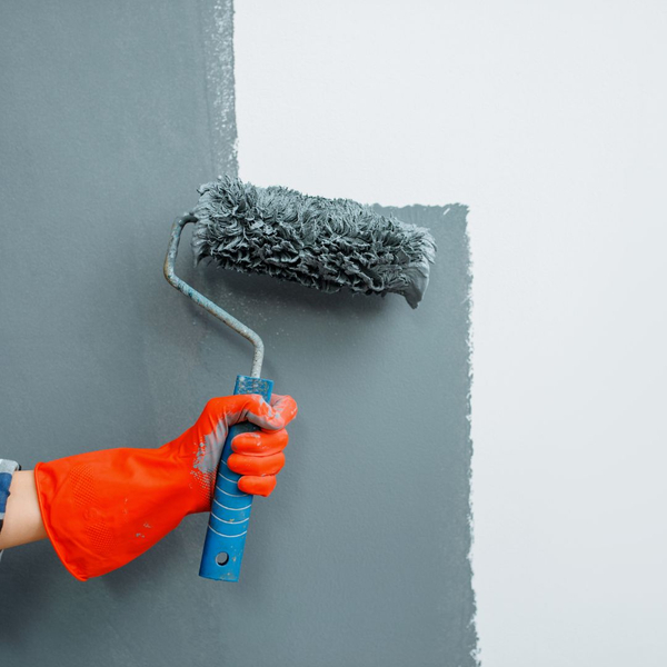 A paintbrush applying paint to a wall