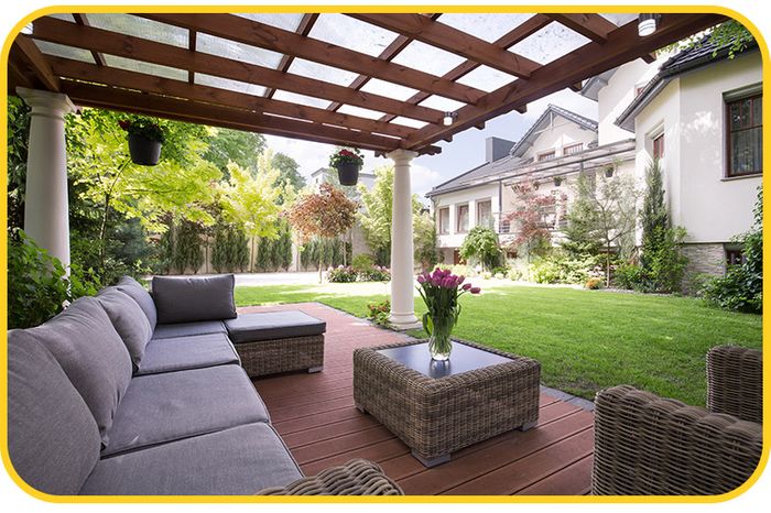 a detached patio with a patio cover in a backyard