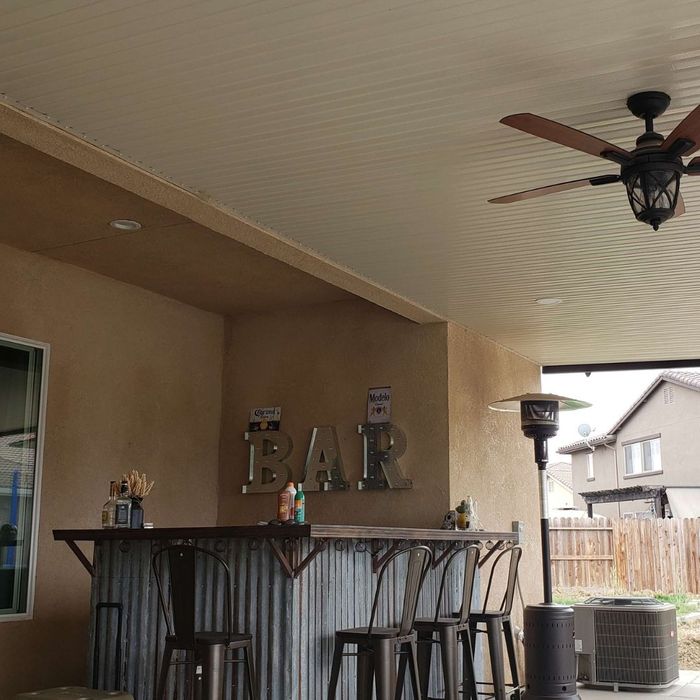 an aluminum patio cover over a patio bar