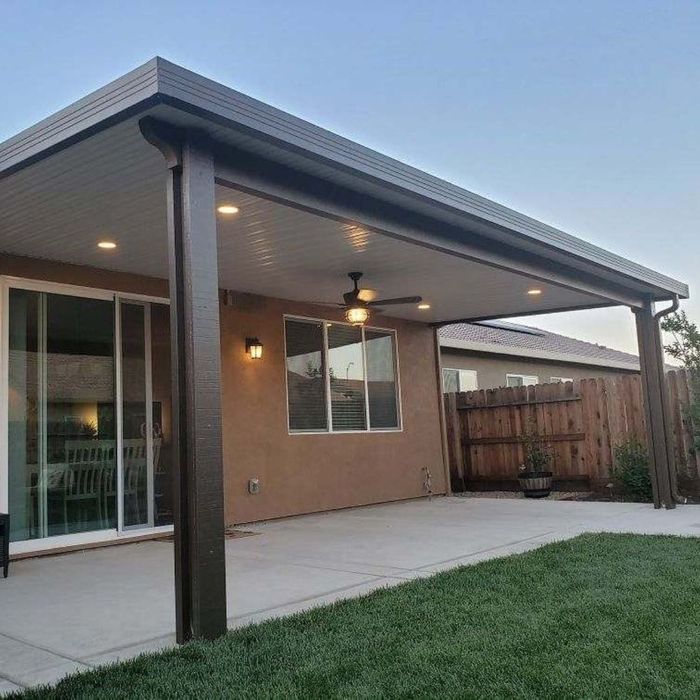 An aluminum patio cover with lights and a fan