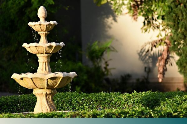 an elegant, three-tiered stone water fountain