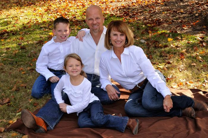 Family of four sitting on a blanket