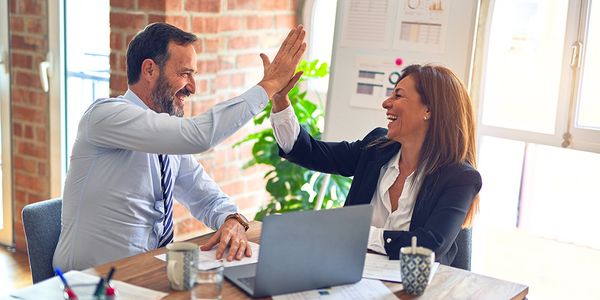 business people giving each other a high five 