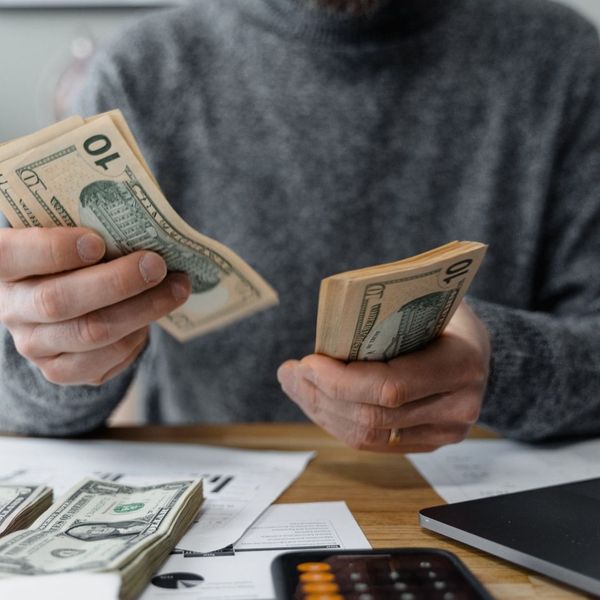 A person at a desk organizing money