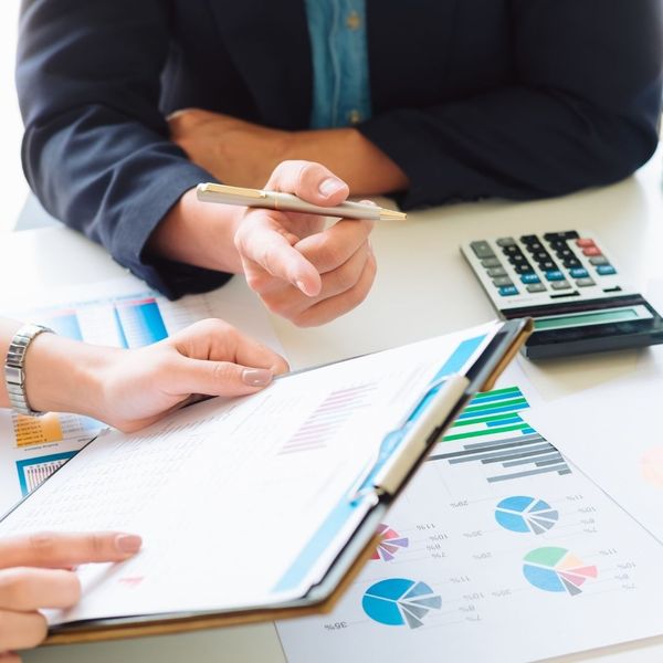 discussing finances charts on clipboard