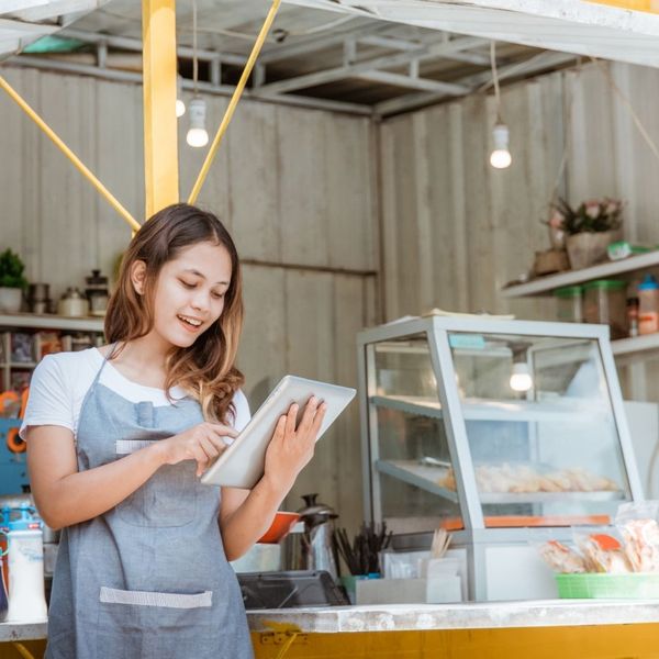 a business owner looking at a tablet a business owner looking at a tablet