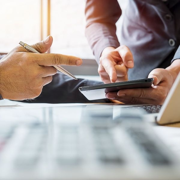 discussing content on tablet with financial advisor