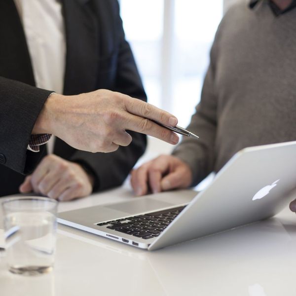 coworkers discussing over laptop