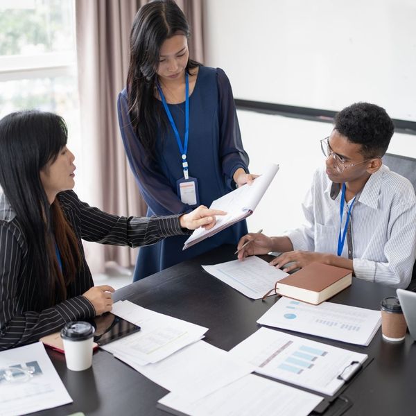 discussing paperwork at meeting desk