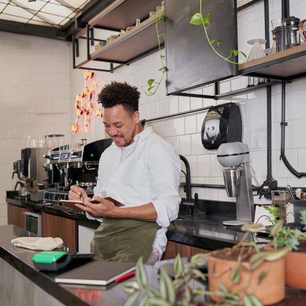 business owner writing in notebook business owner writing in notebook