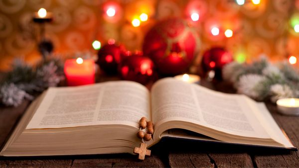 A bible with Christmas ornaments behind it