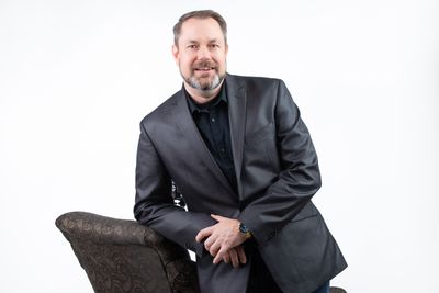 Pastor John with chair.jpg