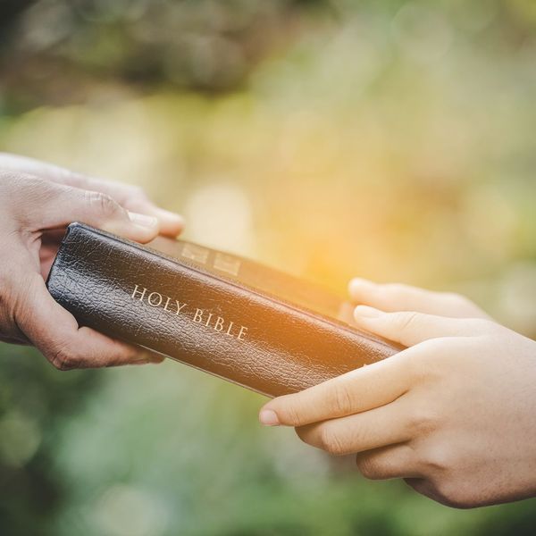 handing bible