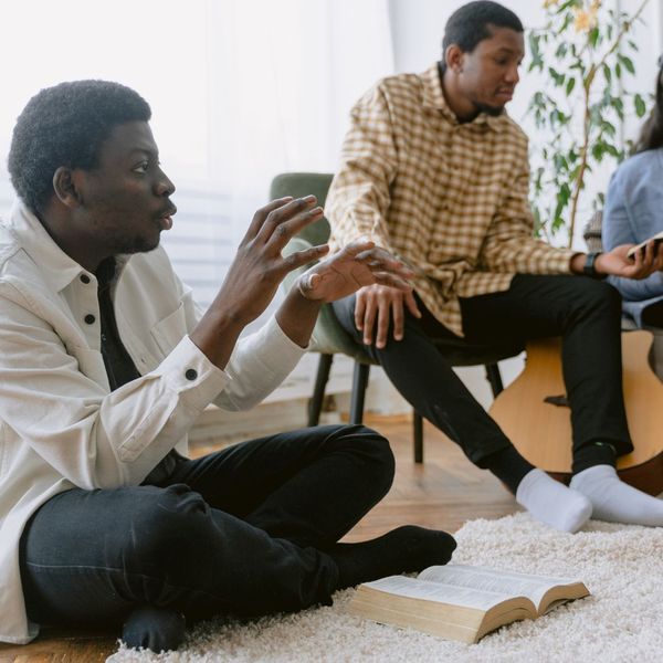three men discussing at a bible study three men discussing at a bible study