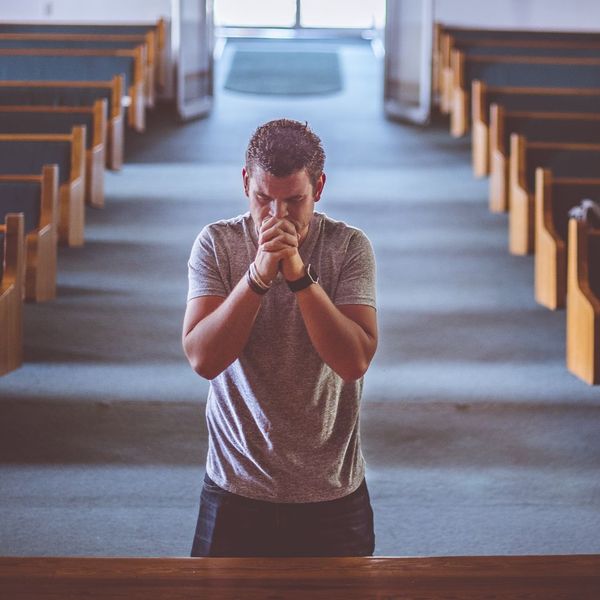 man praying in church