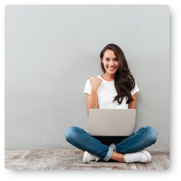 Girl giving a thumbs up while on her laptop