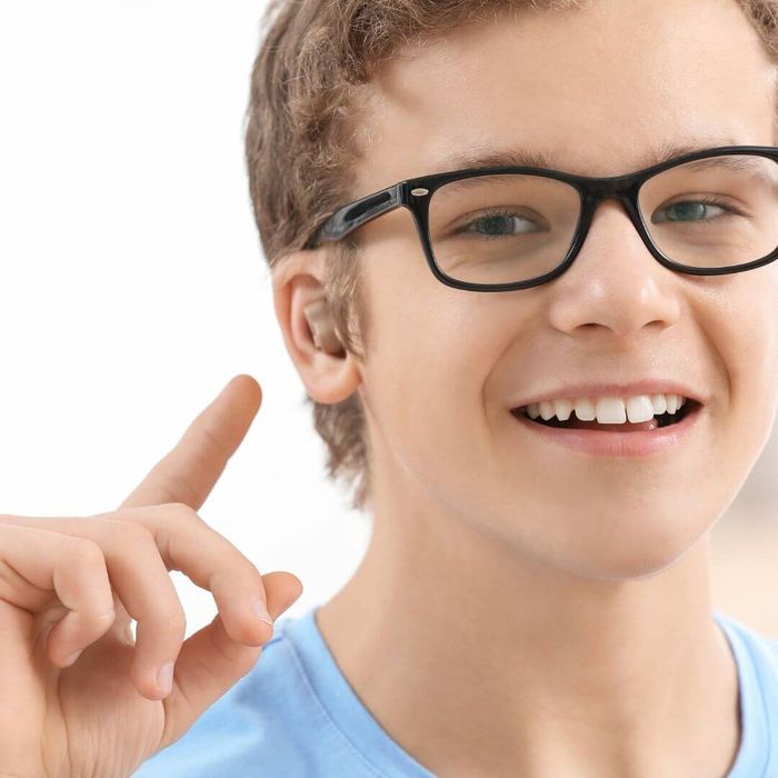a male teenager with a hearing aid