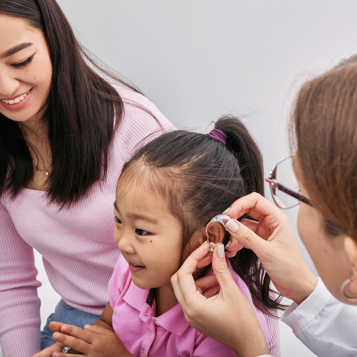 little girl getting hearing aid