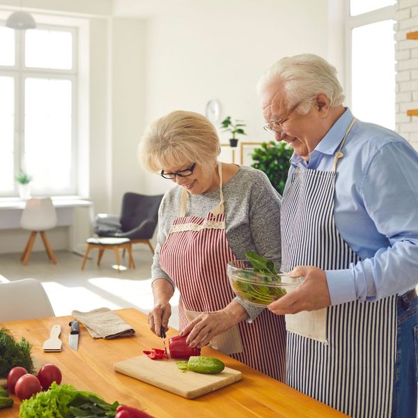 elderly couple making food