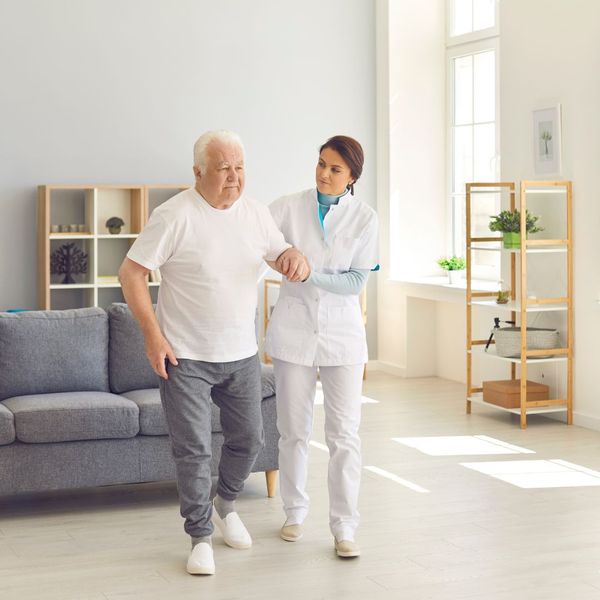 in-home caregiver walking with a senior