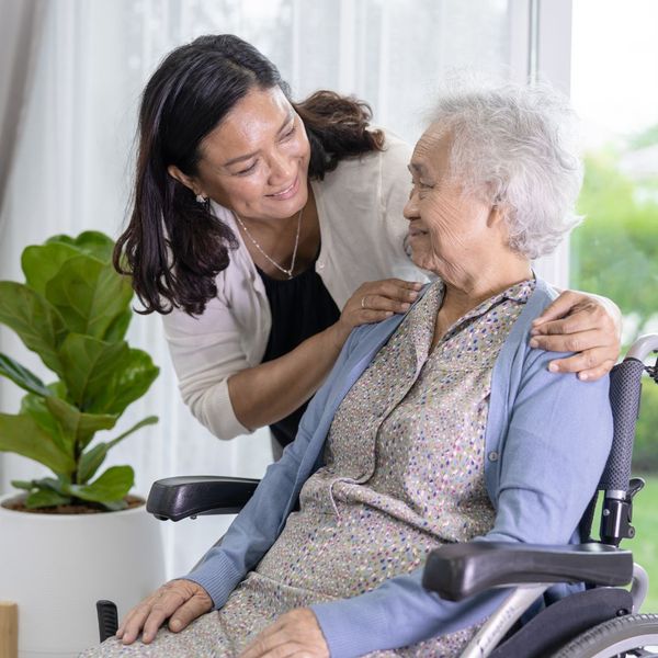 in-home caregiver working with an elderly woman