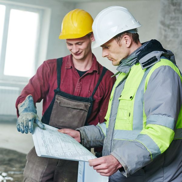 two construction workers looking at plan