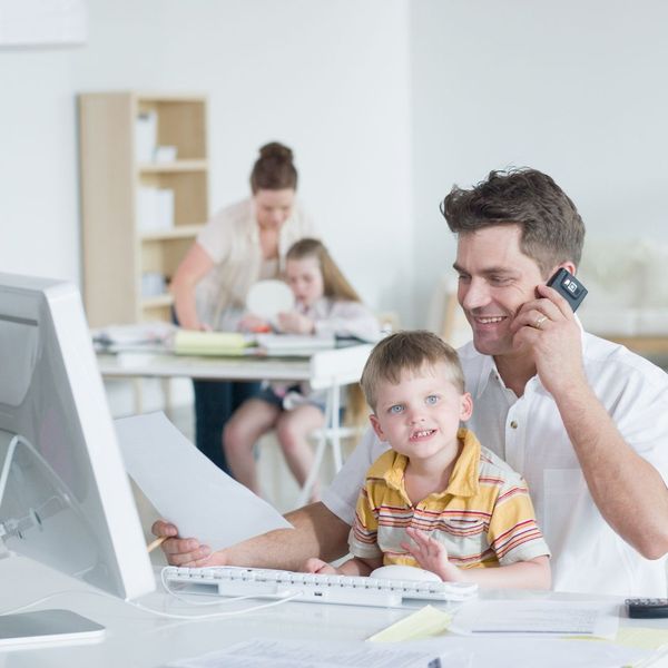 Dad on phone while holding child 