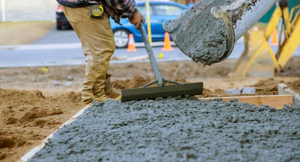 Construction worker pouring concrete