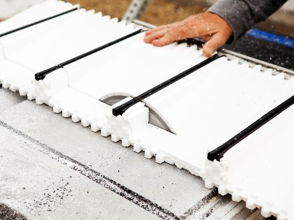 A person cutting an insulated concrete form