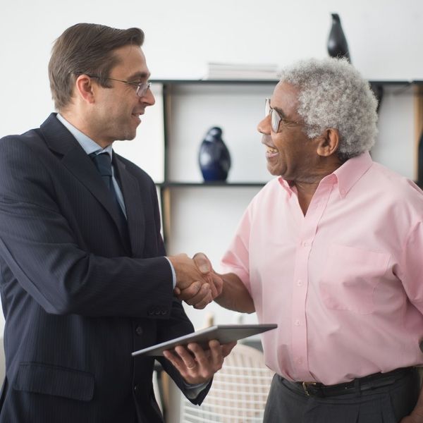 insurance provider shaking hands with a client