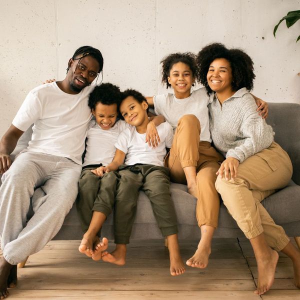 A happy family sitting on a couch