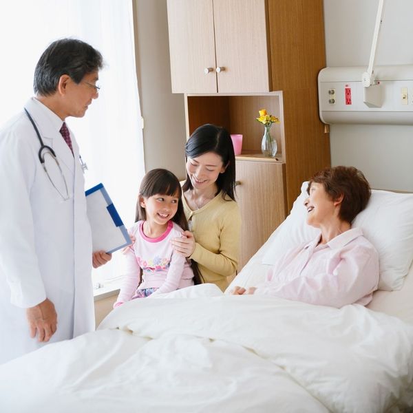 patient, her family, and a doctor in a hospital room