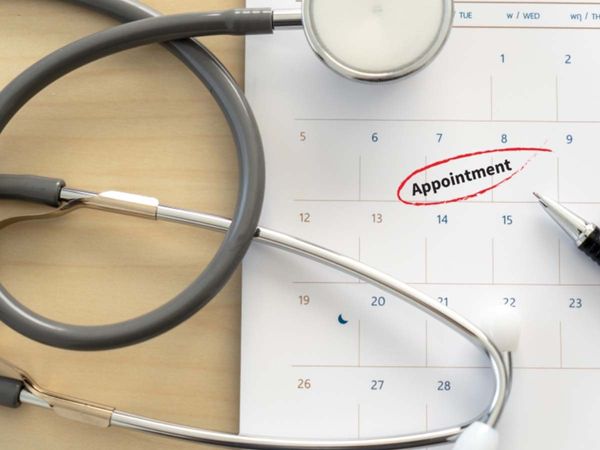  Calendar with the word “appointment” circled next to a pen and stethoscope.