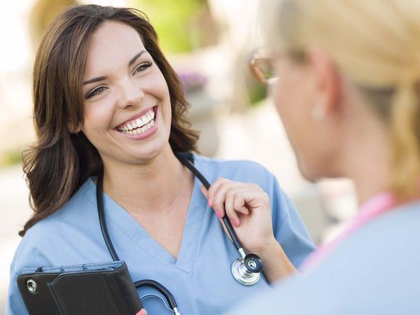 Smiling nurse with a patient.