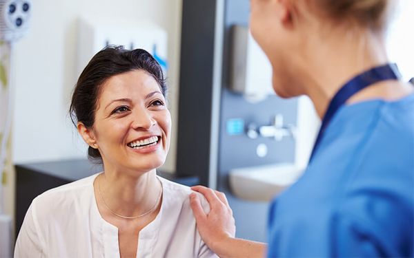 woman talking to nurse about botox