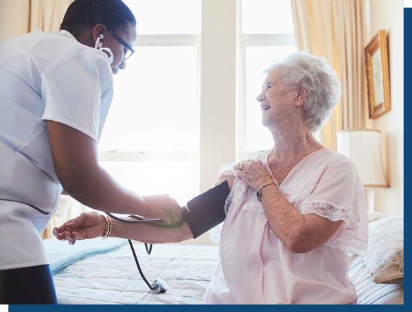Caregiver checking patients blood pressure