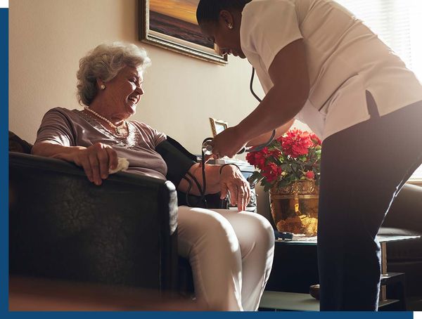 Care giver checking patients blood pressure