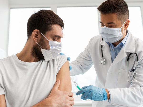 Doctor giving shot to patient
