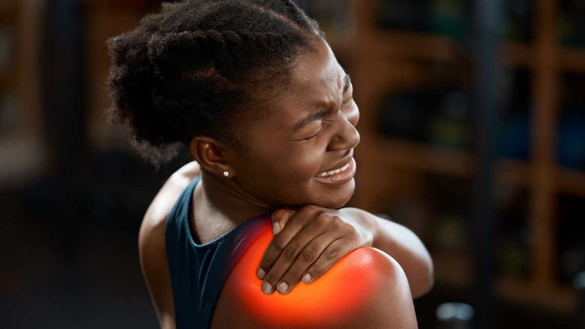 a woman with burning shoulder pain