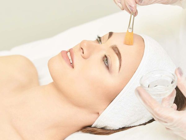 Woman receiving a chemical peel treatment.