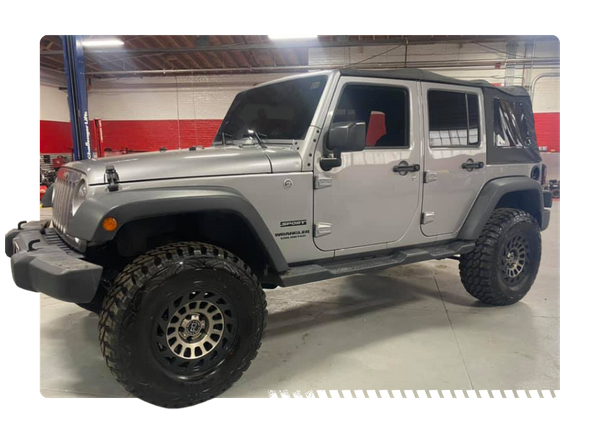 lifted grey soft top four door jeep