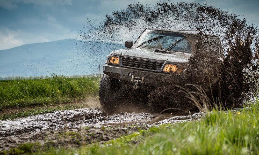 vehichle off roading through mud puddle