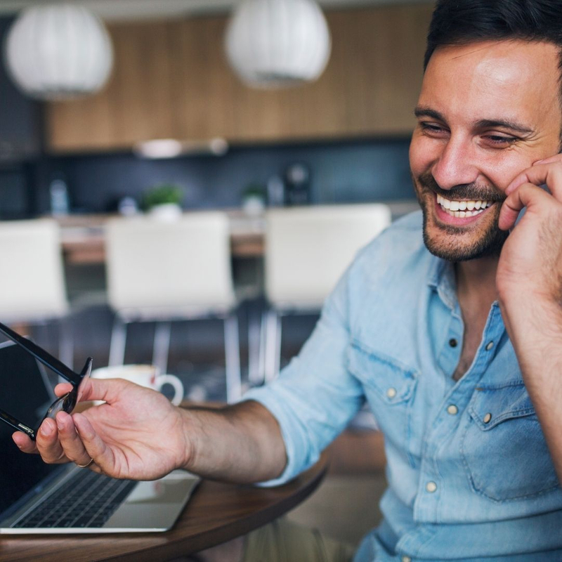 man happily talking on a cell phone