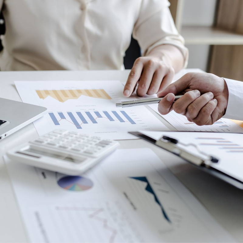 2 people looking at finances on desk