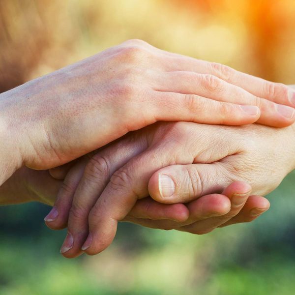 Two people's hands covering one another. 